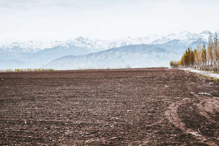 Agricultural land snow mountain black soilの写真素材