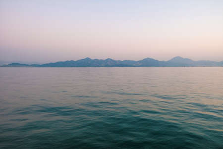 Tranquil sea with sunset viewの写真素材