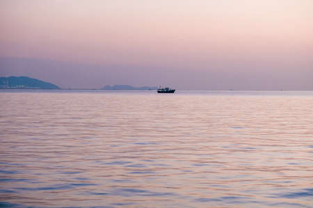 Tranquil sea with sunset viewの写真素材