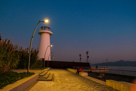 Sunset over seaside with lighthouseの写真素材