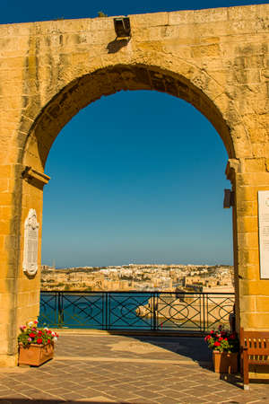 Arch with ancient city in the background and the Mediterranean seaの写真素材