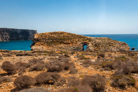 rocky beach with blue waterの写真素材