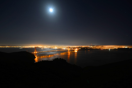 Golden Gate Bridge at night, with San Francisco city skyline at back ground, San Francisco, California, USAの写真素材