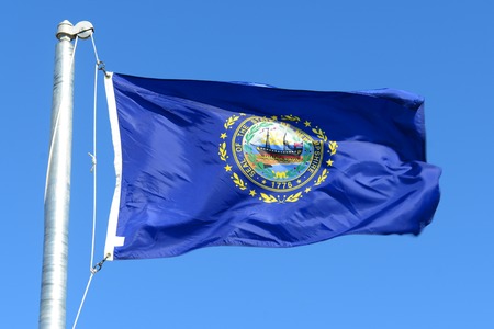 Flag of State of New Hampshire in blue sky backgroundの写真素材