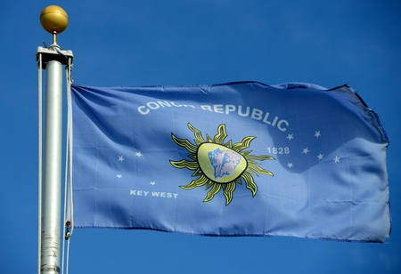 Flag of Conch Republic in blue sky background. Conch Republic was a nation declared by the city of Key West, Florida in 1982 for tourism purpose.の写真素材