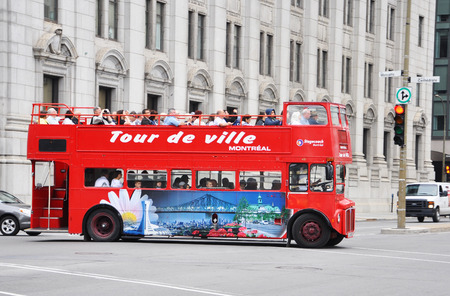 MONTREAL - AUG 4: British style Double-decker tour bus Tour de ville on Aug 4, 2011 in downtown Montreal, Quebec, Canada.のeditorial素材