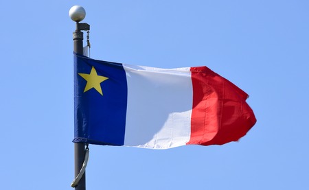 Flag of Acadia flying in Wolfville, Nova Scotia, Canada. The Flag of Acadia was adopted on August 15, 1884 in memory of the Acadian delegates.の写真素材