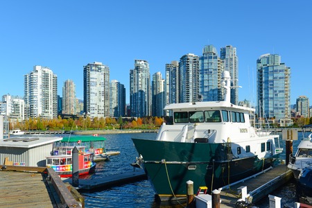 Fishing Boat docked in False Creek with Skyscrapers at the background, Vancouver, British Columbia, Canada.のeditorial素材