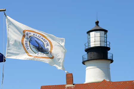 Flag of Town of Cape Elizabeth with Portland Head Lighthouse at the background, Cape Elizabeth, Maine, USA. This lighthouse was built in 1791, and is the oldest lighthouse in Maine.の写真素材