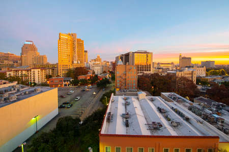 Historic Building on E Commerce St with Weston Centre and Nix Professional Building at the background at sunrise in downtown San Antonio, Texas, USA.