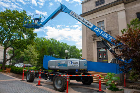 Aerial work platform on a construction site in downtown Cambridge, Massachusetts MA, USA.