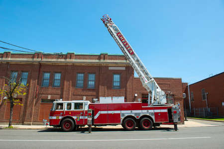 Chelsea Fire truck Ladder 3 raised the ladder in downtown Chelsea, Massachusetts MA, USA.