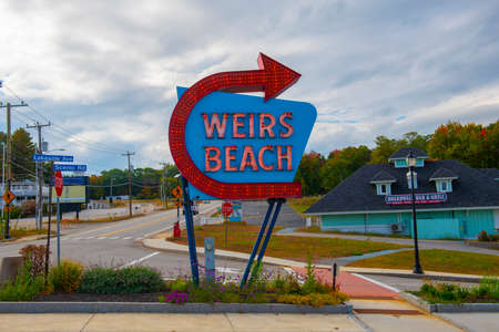 Entrance sign of Weirs Beach with neon lights in village of Weirs Beach in City of Laconia, New Hampshire, USA.のeditorial素材