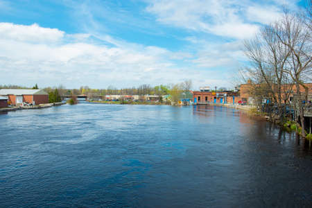 Racquet River flows in historic town center of Potsdam in spring, Potsdam, Upstate New York NY, USA.