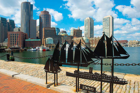 Antique ships sculpture with Boston Rowes Wharf and modern Financial District skyline at the background, city of Boston, Massachusetts MA, USA.のeditorial素材