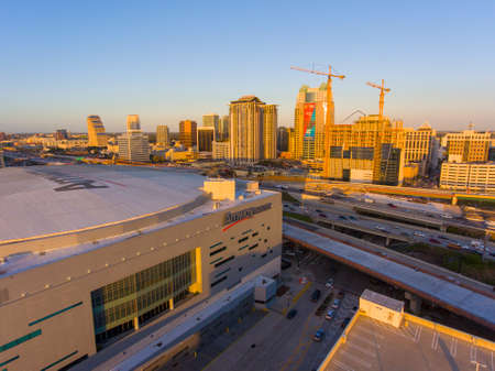 Amway Center aerial view at sunset with Orlando modern business district skyline at the background in city of Orlando, Florida FL, USA. This indoor arena is the home to the Orlando Magic of NBA.のeditorial素材