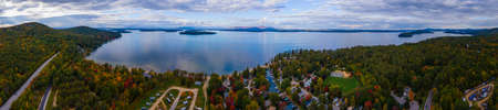 Aerial view of Lake Winnipesaukee in fall with Ossipee Mountains at the background, from Ellacoya State Park in town of Gilford, New Hampshire NH, USA. This mountains belong to White Mountains.の写真素材