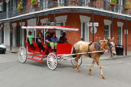 Horse drawn carriage tour on Royal Street at Dumaine Street in French Quarter in New Orleans, Louisiana LA, USA.のeditorial素材