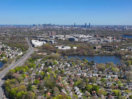 Arlington Heights suburban landscape aerial view in spring with Little Pond and Boston modern city skyline at the background in historic town of Arlington, Massachusetts MA, USA.の写真素材