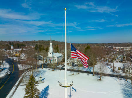 USA National Flag on Lexington historic town center aerial view in winter, with First Parish Church at the background, town of Lexington, Massachusetts MA, USA.の写真素材
