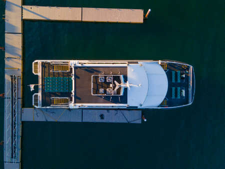 Whale watch ship aerial view docked at pier at sunset in historic town center of Bar Harbor on Mt Desert Island, Maine ME, USA.の写真素材