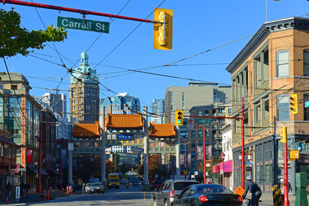 Historic commercial buildings on 1 W Pender Street with Milennium Gate at the back in historic Chinatown in city of Vancouver, British Columbia BC, Canada.のeditorial素材