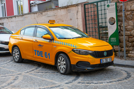 Istanbul yellow taxi on Amiral Tafdil Sk Street in Sultanahmet in historic city of Istanbul, Turkey.のeditorial素材