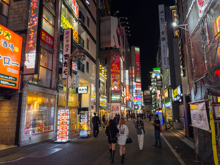 Shops and restaurants at night on Kabukicho Ichiban Gai Street in Shinjuku, Tokyo, Japan.のeditorial素材