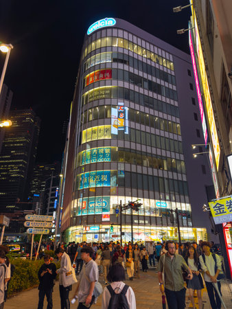 Welcia shopping mall with neon light at night on Ome-kaido Avenue and Otakibashi dori at Sinjukuogado West, Shinjuku City, Tokyo, Japan.のeditorial素材