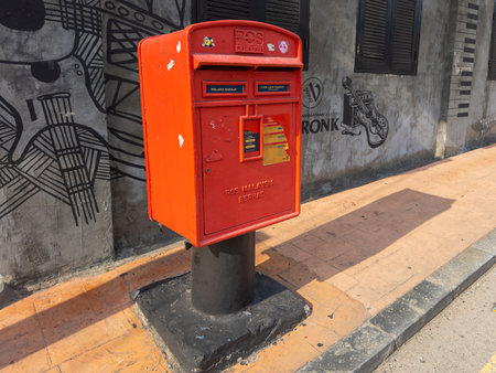 Malaysian red post mailbox in city center of Melaka, Malaysia. Historic cities of the Strait of...