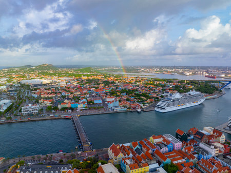 Koningin Emmabrug floating bridge aerial view which connects Punda and Otrobanda, with rainbow at the background in city of Willemstad, Curacao. Historic Willemstad is a UNESCO World Heritage Site.の写真素材