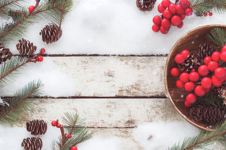 Merry Christmas frame decoration with real wood green pine, colorful baubles, gift boxes and other seasonal items set against an aged wooden background. Merry Christmas and Happy New Year theme.の写真素材