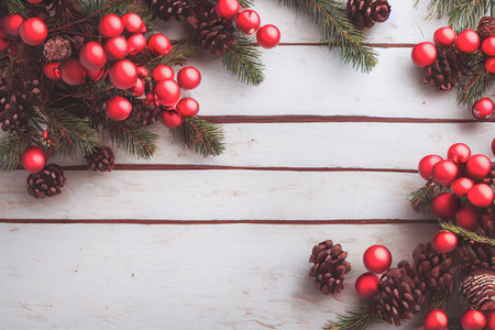 Merry Christmas frame decoration with real wood green pine, colorful baubles, gift boxes and other seasonal items set against an aged wooden background. Merry Christmas and Happy New Year theme.の写真素材