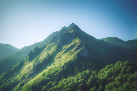 Beautiful sunrise over the green mountains in morning light with fluffy clouds on a bright blue sky. Nature freshness concept.の写真素材