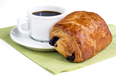 Cup of coffee and chocolate croissant on white background の写真素材