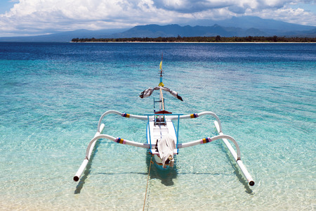 Boat on the sea and coastlines of Gili island, Trawangan, Indonesia.の写真素材
