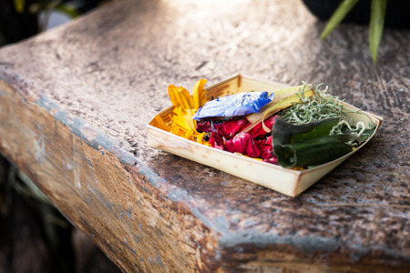 Traditional balinese offerings to gods in Bali with flowers, Indonesiaの写真素材