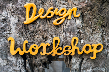 Ubud, Bali, Indonesia - March 7 2014, yellow sign with word design and workshop on vintage wood -...