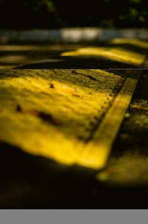 A vertical closeup shot of a yellow line on a road surfaceの写真素材