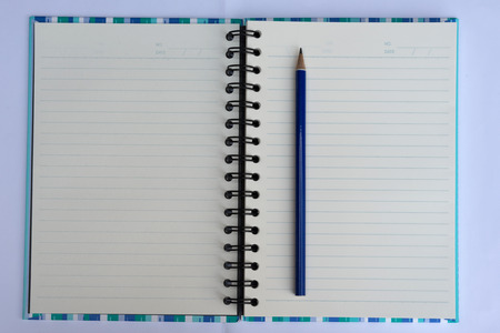 Open Spiral Bound Notebook and pencil Isolated on White の写真素材