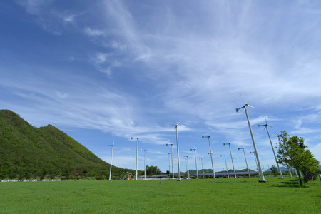 green meadow with Wind turbines generating electricityの写真素材