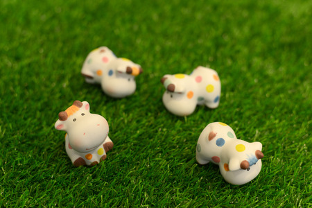 Cow doll on the green grass.の写真素材