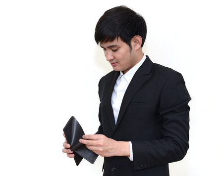 Asian handsome Business man looking at his empty wallet. Isolated on a white background.