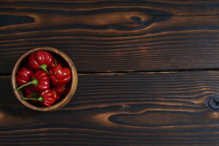 Close-Up of Habanero Pepper Against Wooden Backgroundの写真素材