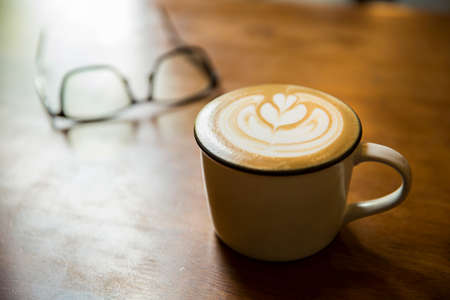 Coffee with smart phone on a deskの写真素材