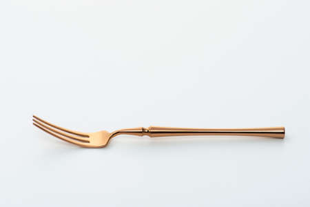Golden fork isolated on white background.Studio shot.の写真素材