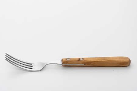 Wooden fork isolated on white background. Studio shot.の写真素材