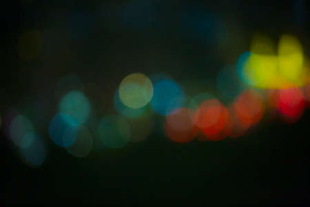 Traffic light at night, defocused bokeh light, blue color toned, abstract.