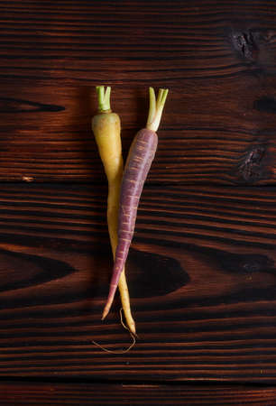 Color carrot with leaves at organic greengrocer's shop. stock photo.の写真素材