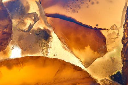 Macro shot of yellow stone crystal on white background close-up.